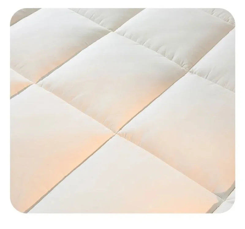 Detailed view of white quilted mattress topper pad stitching pattern