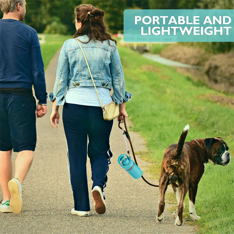 Dog owner walking with compact poop scooper clipped by lanyard