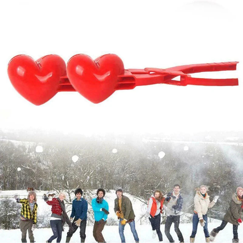 Double heart snowball clip mold held above snowy outdoor scene with people playing