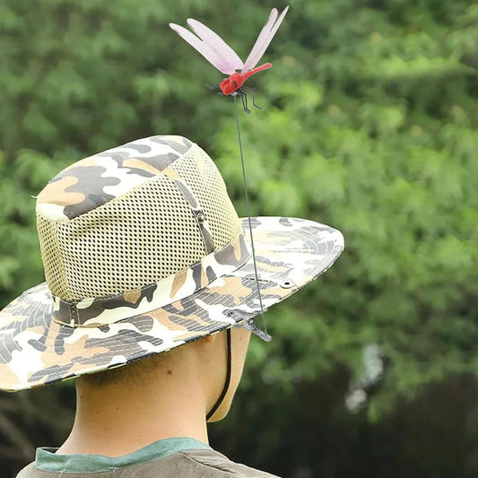 Dragonfly clip decoration attached to camouflage hat for outdoor insect deterrent