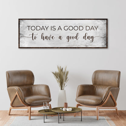 Today Is a Good Day thin script canvas sign above two brown leather armchairs
