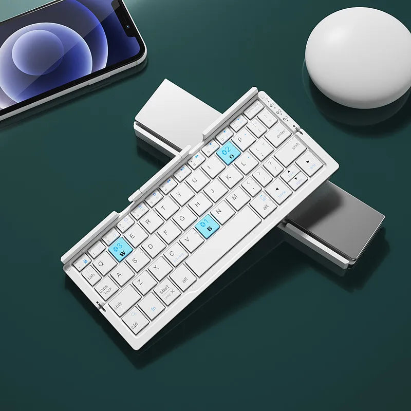 Foldable keyboard  for phone on a dark surface with a smartphone and white ball in the background