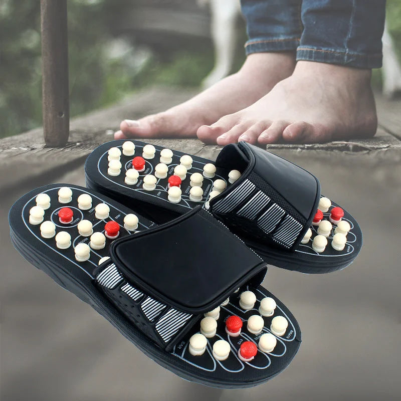Foot massage slippers worn outdoors on wooden surface showing pressure point layout