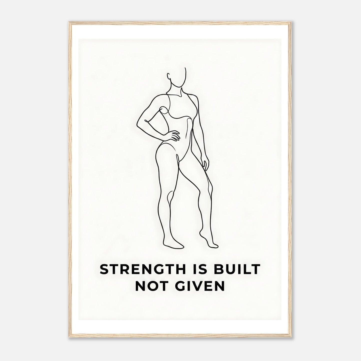 Framed artwork with a line drawing of a person and the text 'Strength is built not given' on a white background.