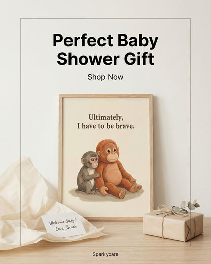 Framed artwork with two monkeys, one larger and one smaller, on a wooden surface with a gift box and card.