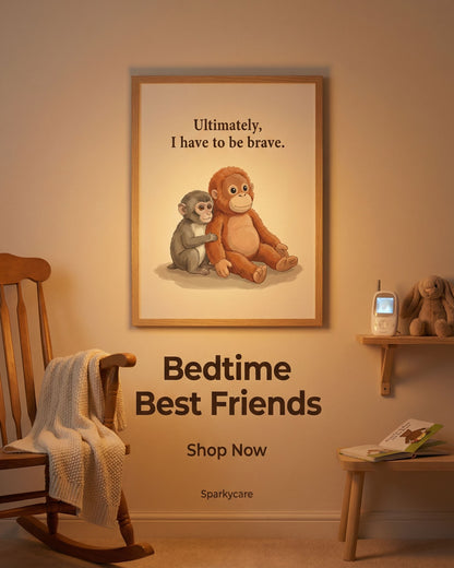 Framed picture of two monkeys with a quote on a wall in a nursery setting.