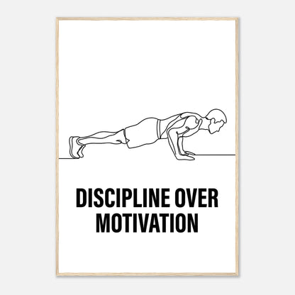 Framed poster with a line drawing of a person doing push-ups and the text 'Discipline Over Motivation' on a white background.