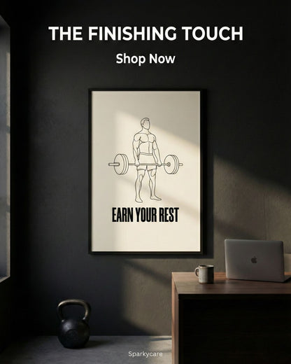 Framed poster with a man lifting weights and 'Earn Your Rest' text in a room with a desk and laptop.
