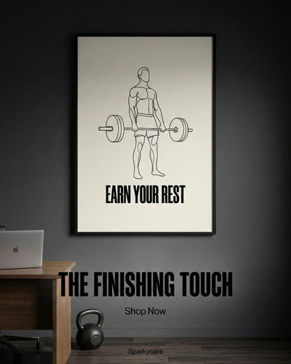 Framed poster with a man lifting weights and 'Earn Your Rest' text on a dark wall.