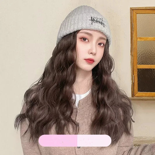 Front view of embroidered beanie hat wig one-piece with long flowing wavy synthetic hair attached