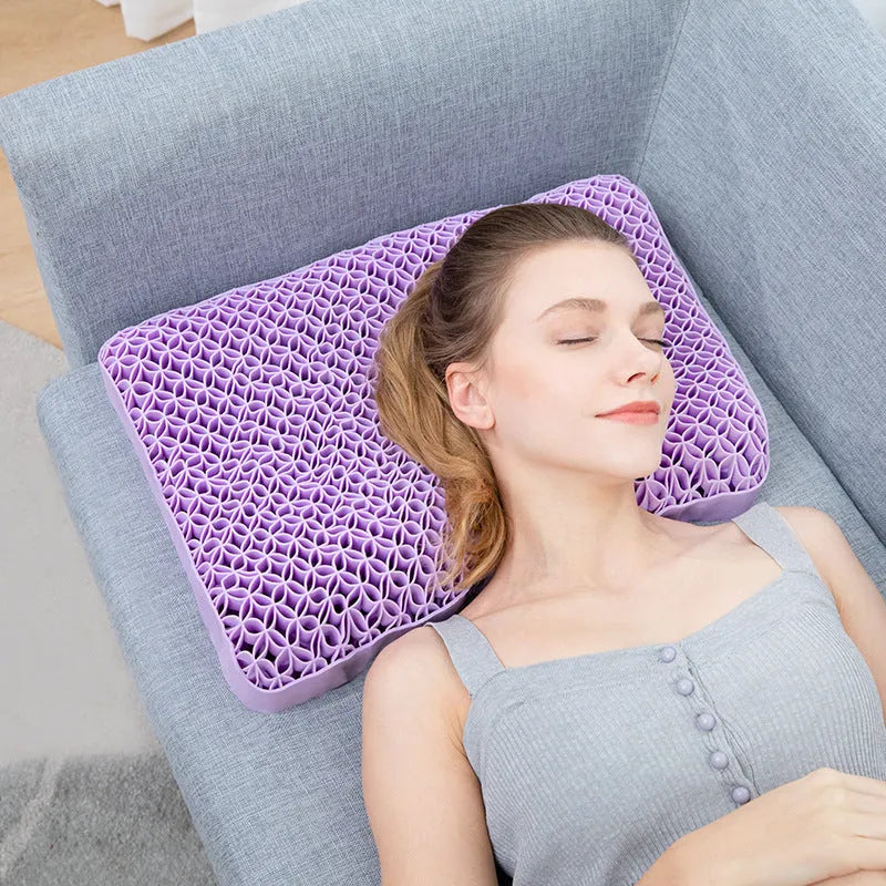 Gel cold pillow supporting head and neck during rest on sofa showing ergonomic cervical shape in purple