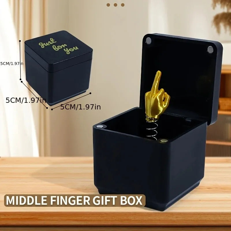 Golden middle finger spring loaded mechanism in open prank box
