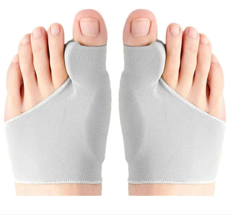 Gray bunion correctors on a person's feet against a white background