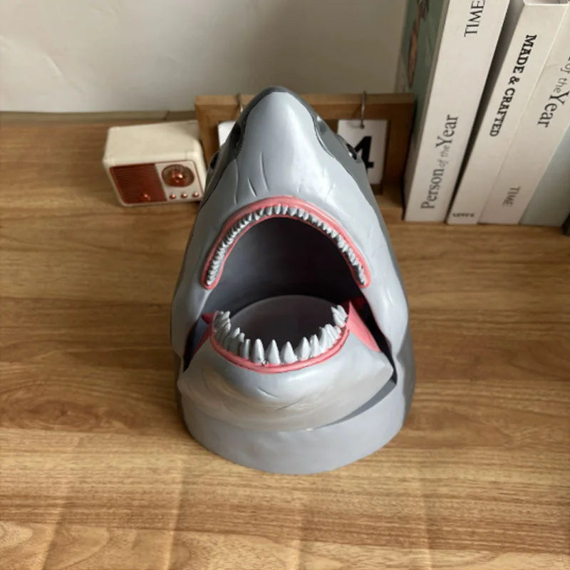 Gray shark popcorn bucket with open mouth showing detailed teeth and pink interior on wooden desk display