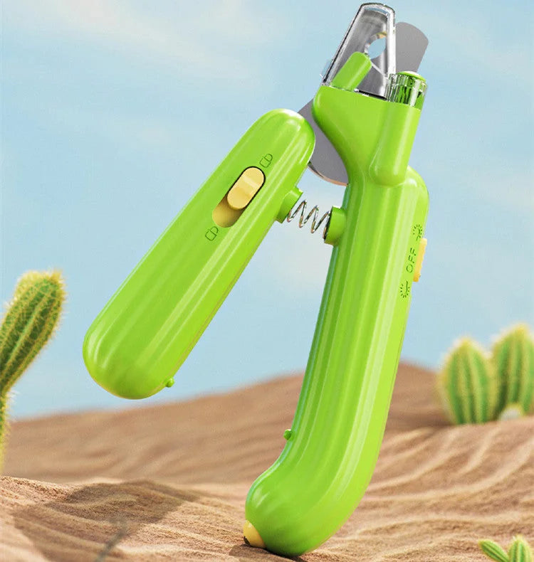 Green LED pet nail clipper displayed open with spring mechanism outdoors.