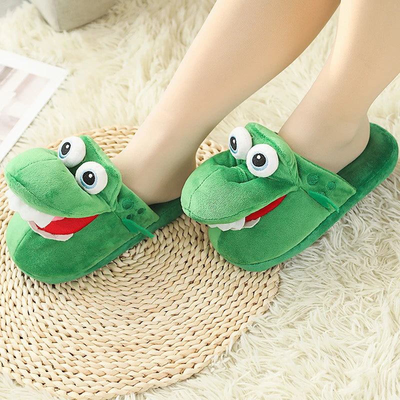 Green aligator-themed slippers worn by a person on a textured floor.