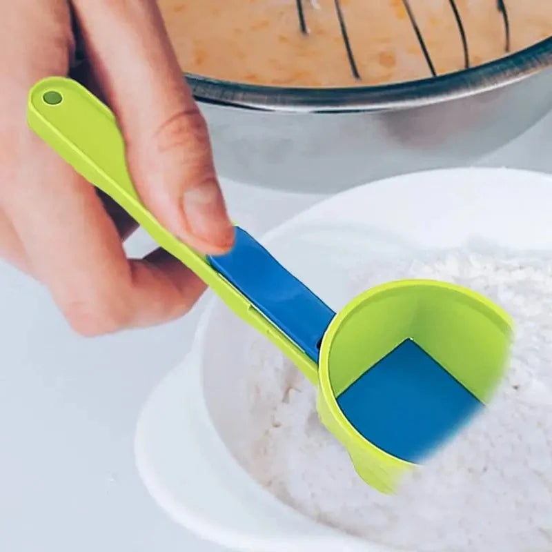 Green and blue measuring scoop being used to measure flour.