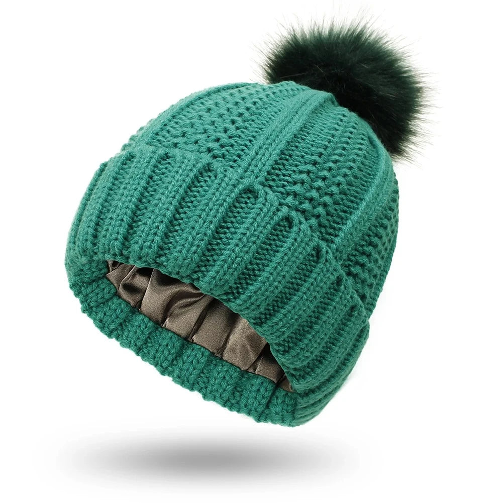 Green cable knit beanie with silk satin interior lining protects hair from frizz