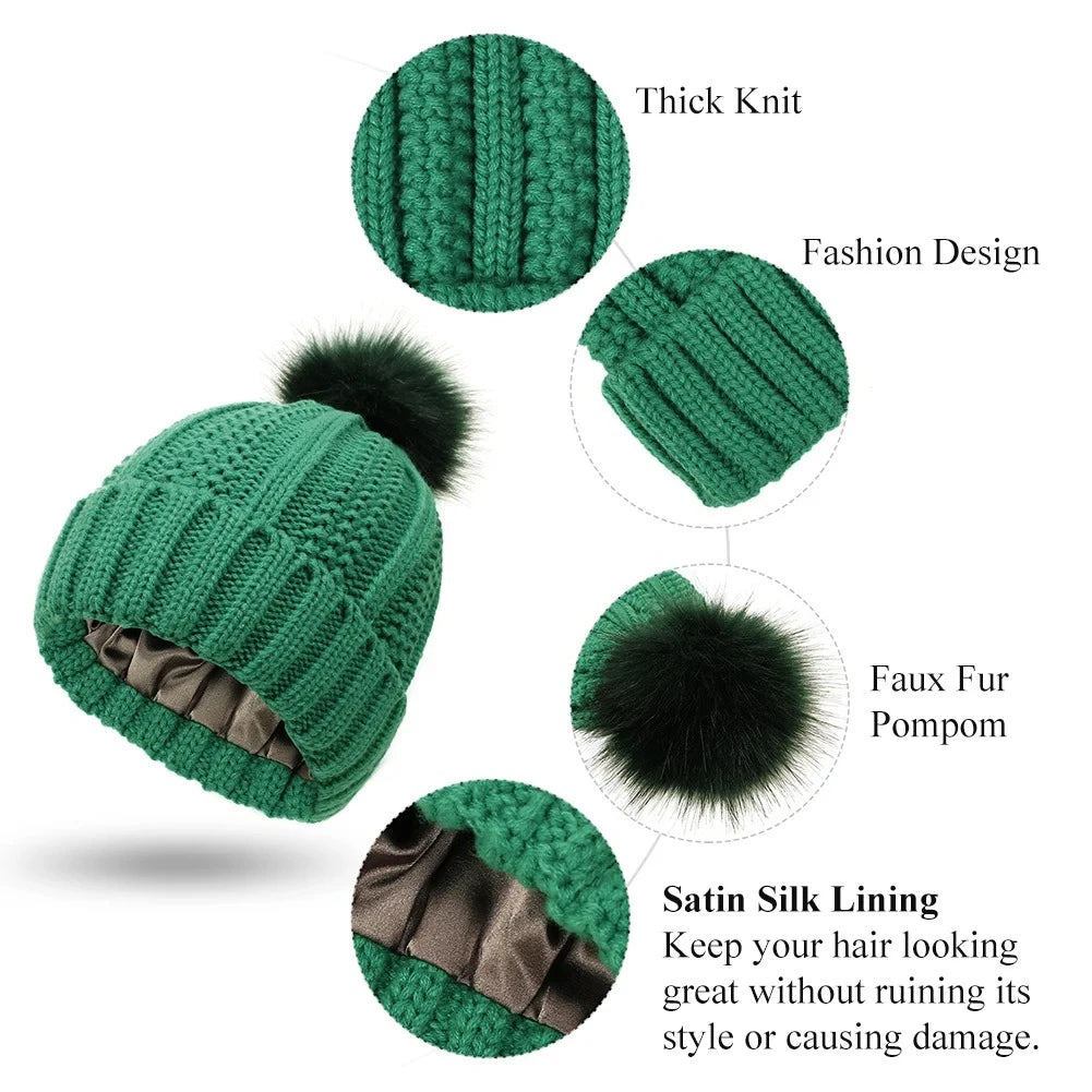 Green knitted beanie with fur pom-pom and satin silk lining, showing features on a white background.