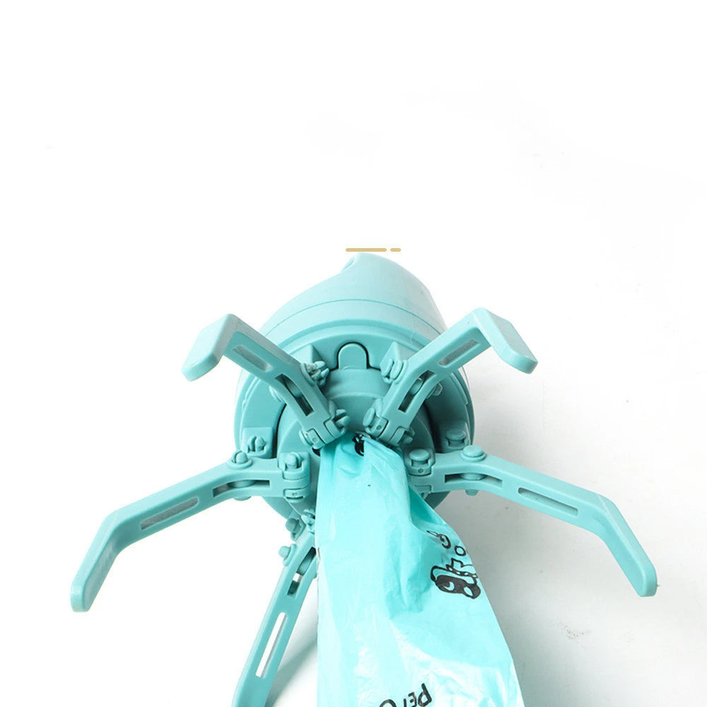 Hand squeezing eight-claw pooper scooper into open bag