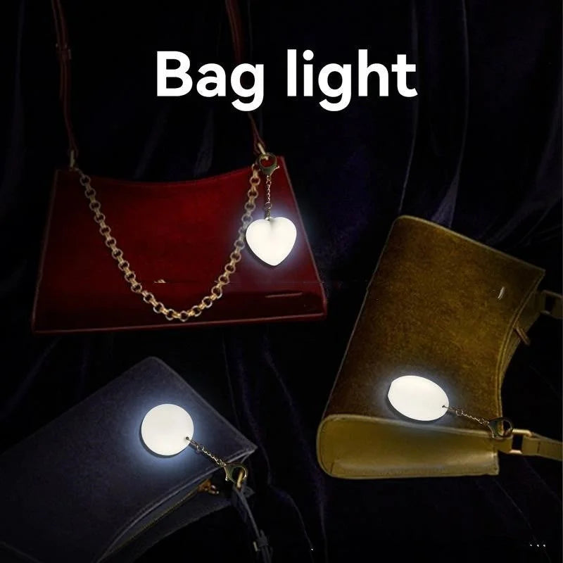 Heart pendant bag lights glowing on different handbags displayed together