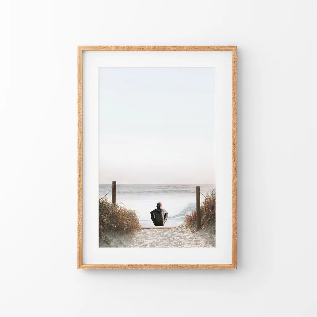 Surfer sitting on the beach, coastal summer wall art print in neutral tones