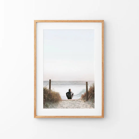 Surfer sitting on the beach, coastal summer wall art print in neutral tones