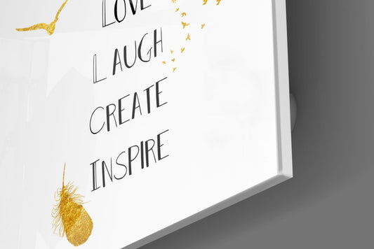 Close-up of the glossy tempered glass edge on the inspirational words with a gold feather glass wall art