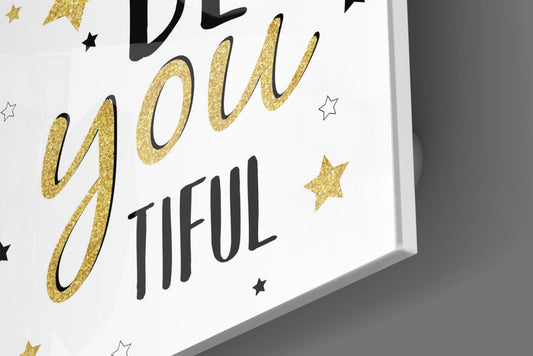Close-up of the glossy tempered glass edge of the Be You Tiful gold stars typography piece