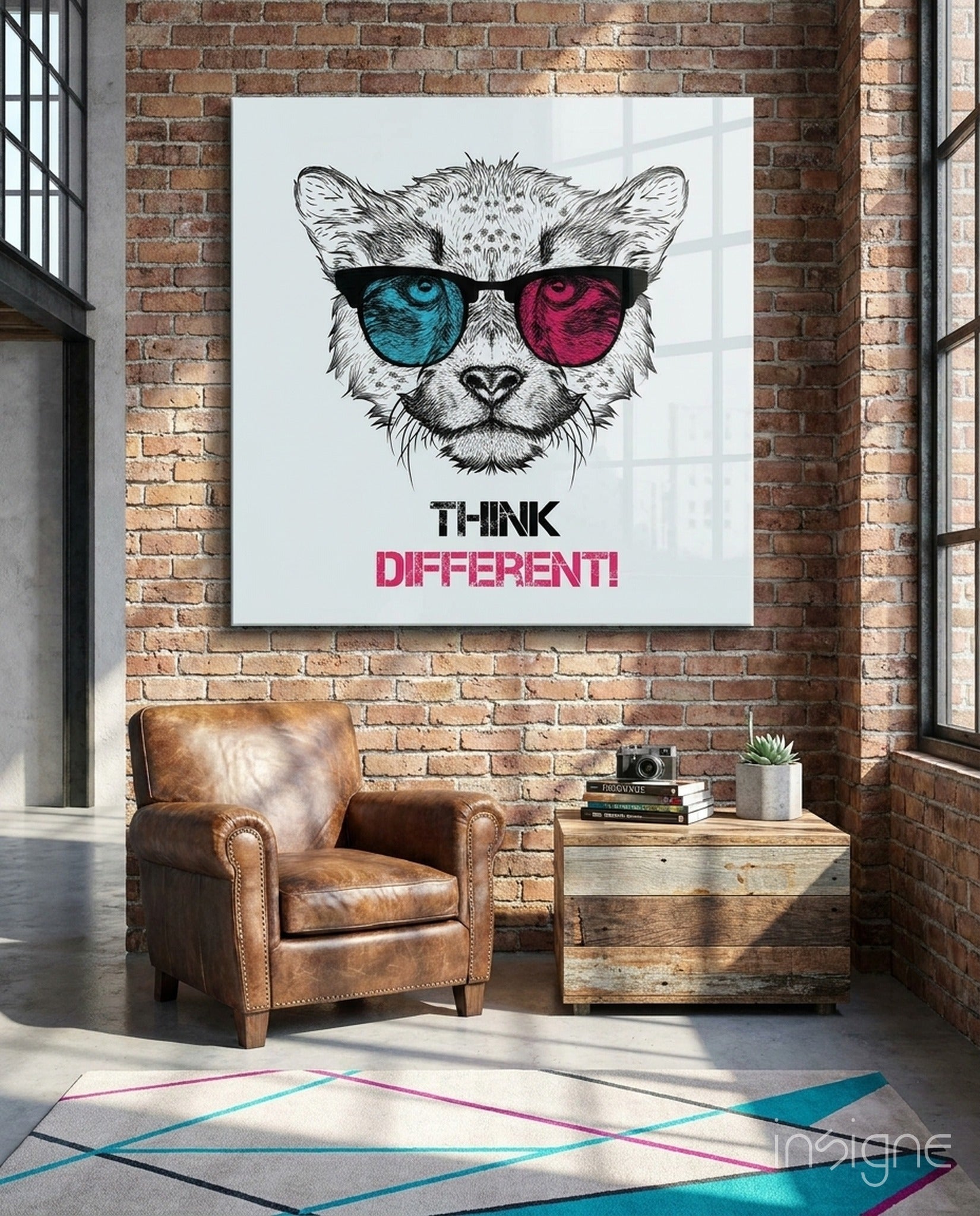 Think Differently glass wall art hanging in a modern living room