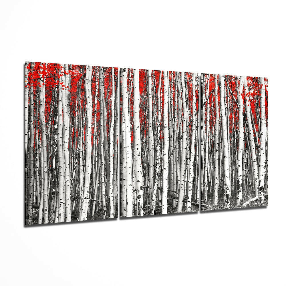 Red forest glass wall art hanging on a wall