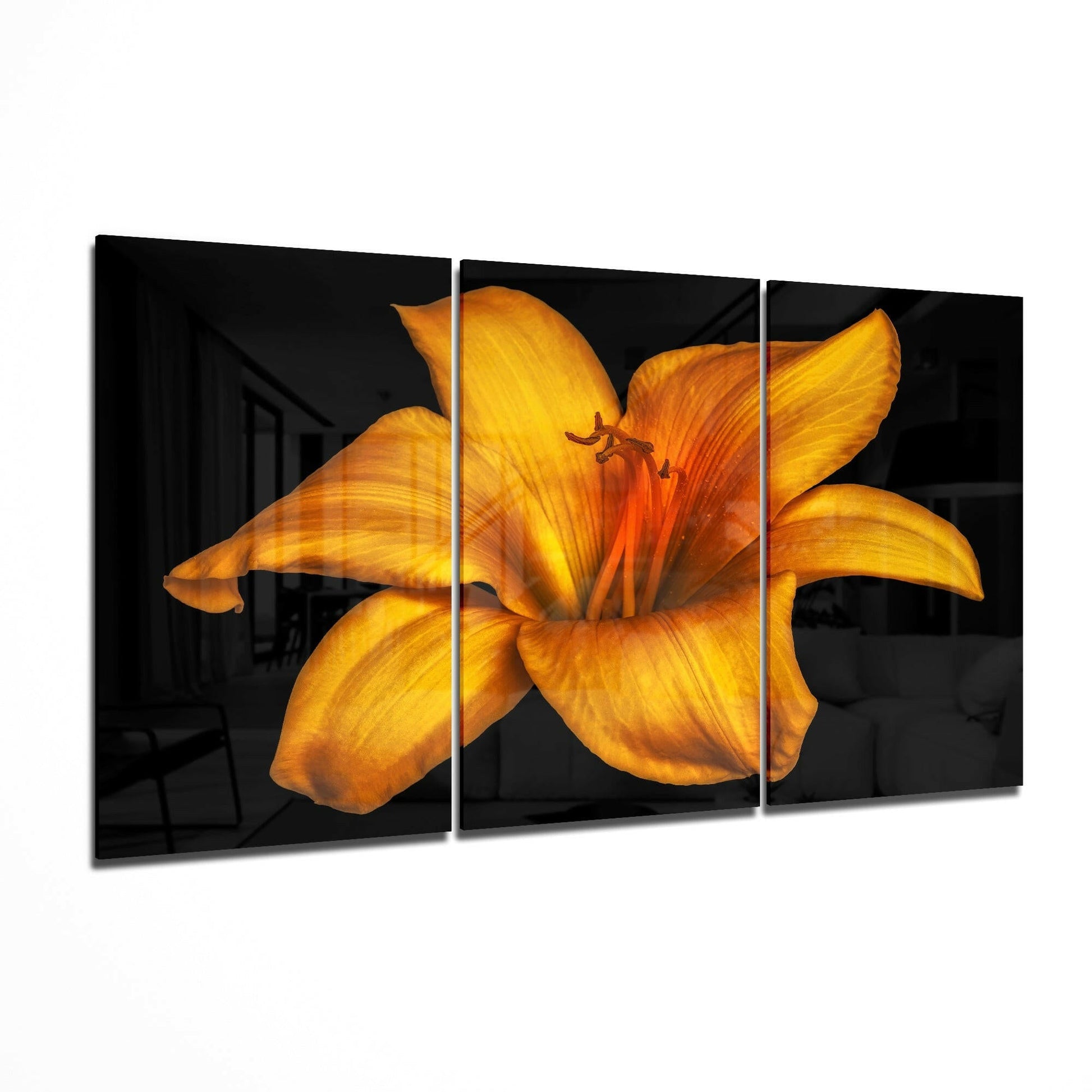 Orange Lilium flower glass wall art displayed on a living room wall