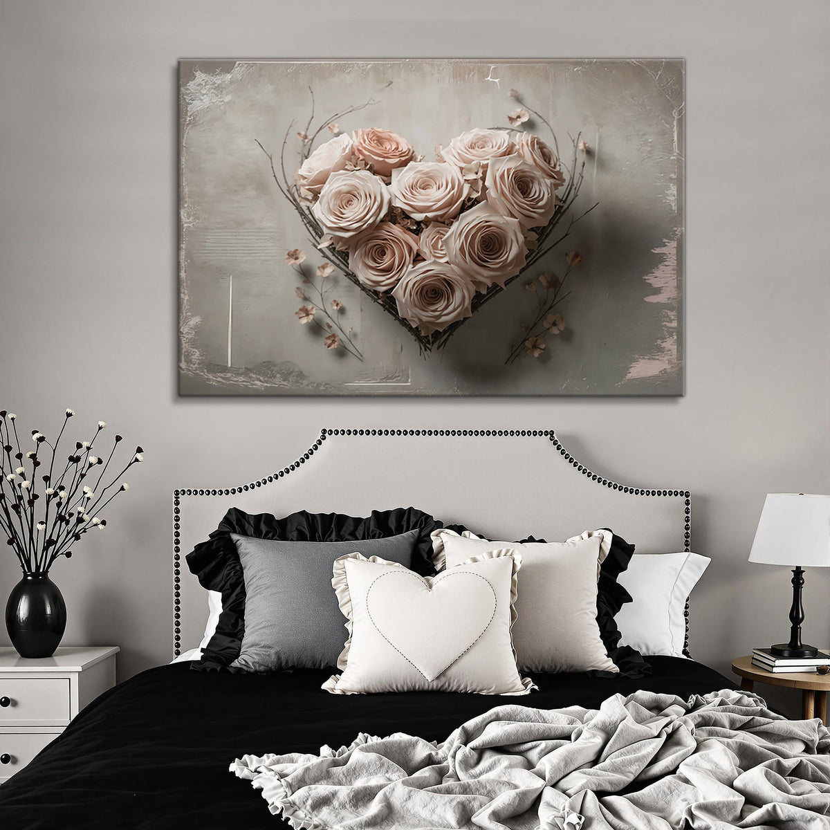 Canvas of a heart of blush roses and twigs on a gray ground above a bed with a studded headboard