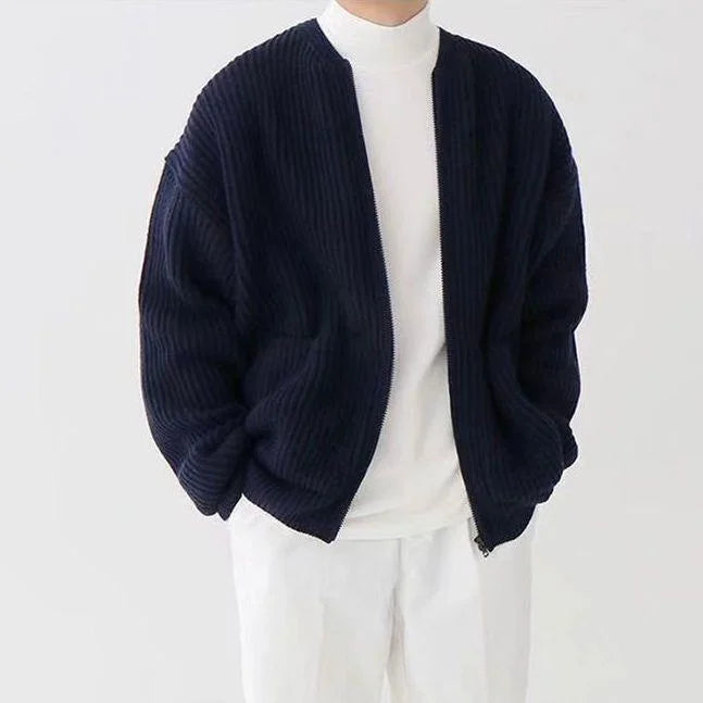 Men’s dark blue knitted cardigan worn with an all-white outfit