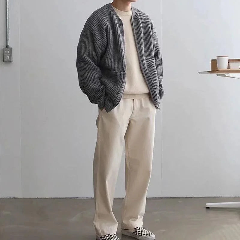 Men’s oversized knit cardigan in gray paired with cream pants for a relaxed look