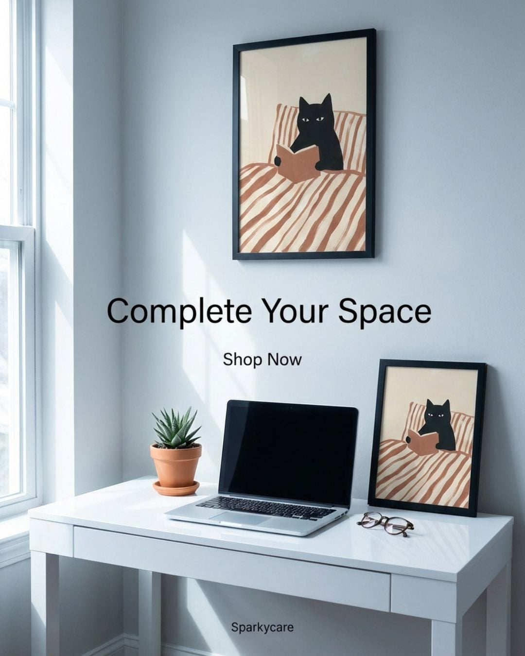 Modern office setup with a desk, laptop, and decorative cat art on a light blue wall.
