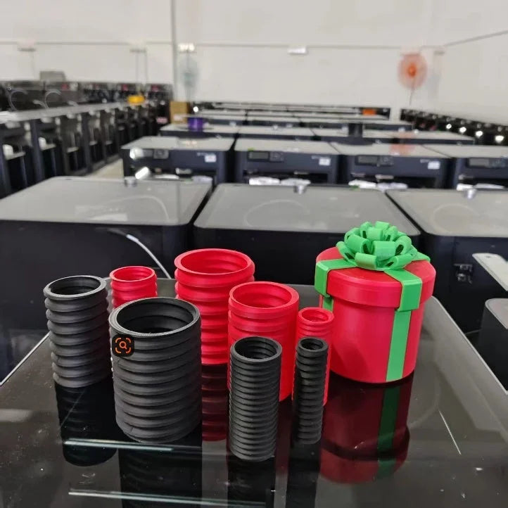 Multiple 3D printed Christmas gift boxes in red, black, and green - matryoshka nesting set display