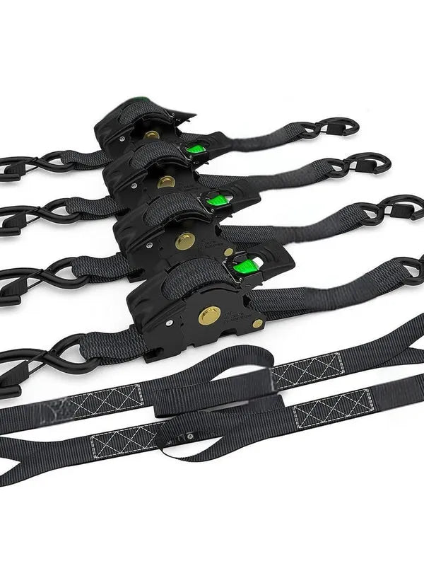 Multiple self retracting ratchet straps lined up showing locking system and reinforced stitching, black straps with green accents