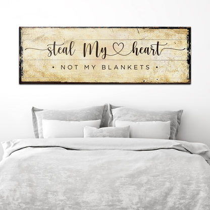 Wide Steal My Heart canvas sign in script on aged tan parchment, above a bed with white linens, above bed decor