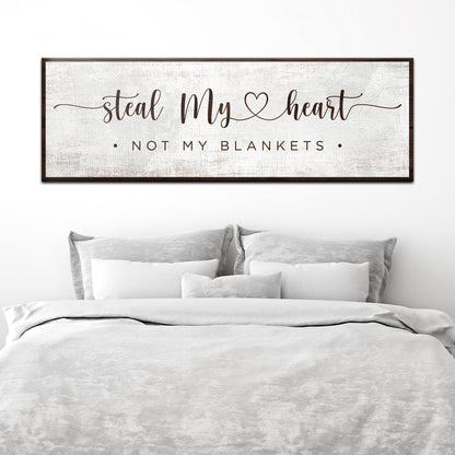 Steal My Heart Not My Blankets canvas sign in the clean white style, above a bed with white linens