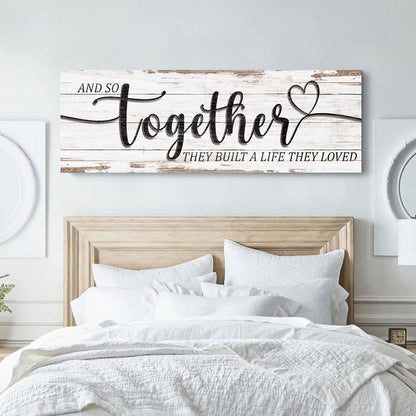 And So Together canvas sign with large black script and a heart on a whitewashed wood-look background above a bed