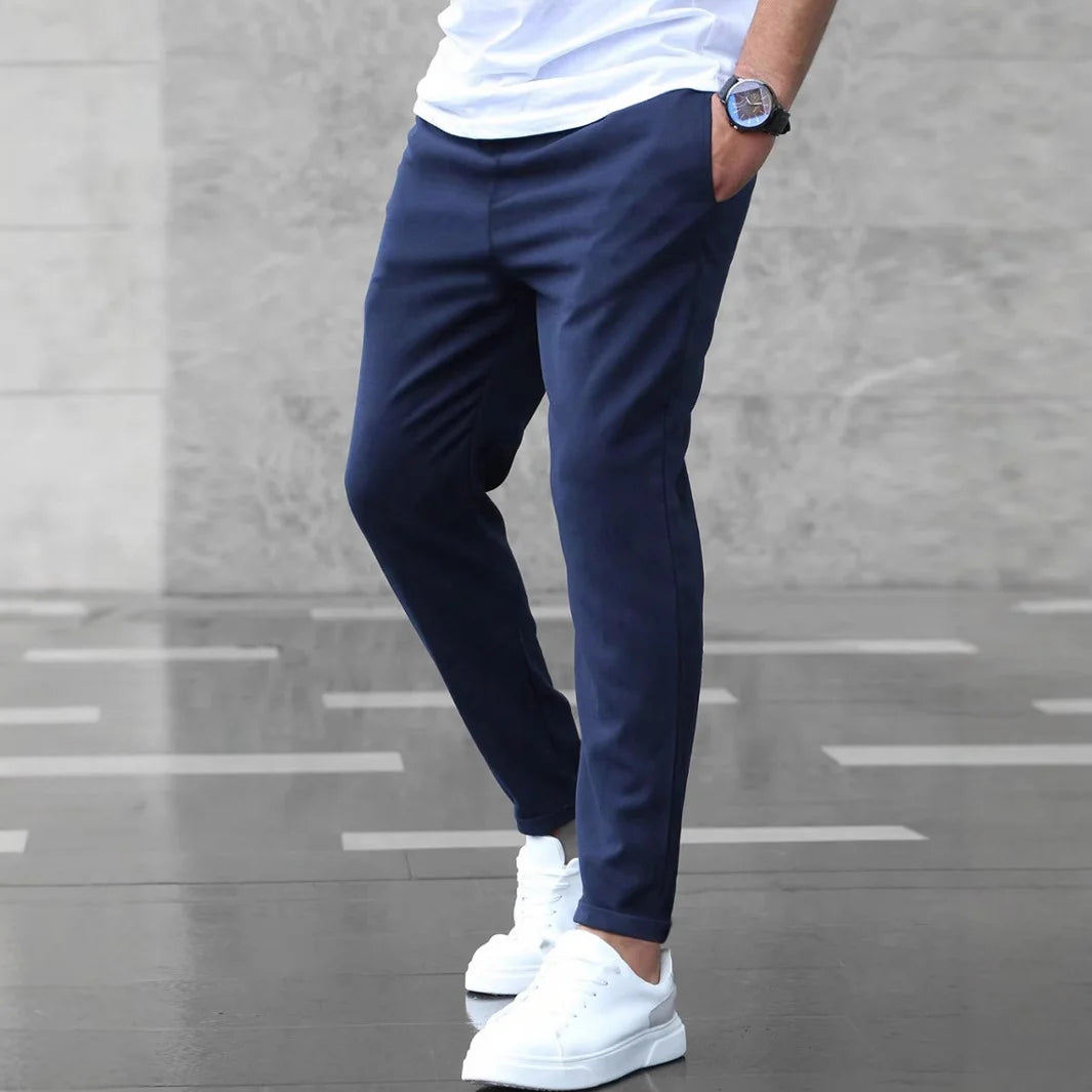 Navy Blue slim-fit men’s stretch trousers styled with white sneakers