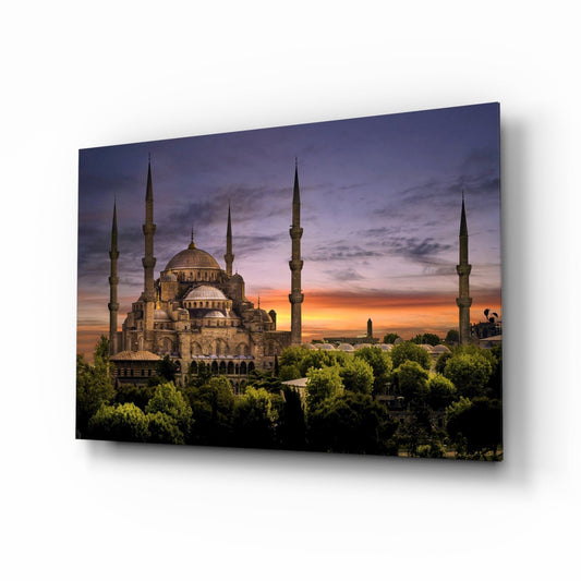 Mosque at purple dusk glass wall art, domes and minarets above green trees under a violet and peach sky