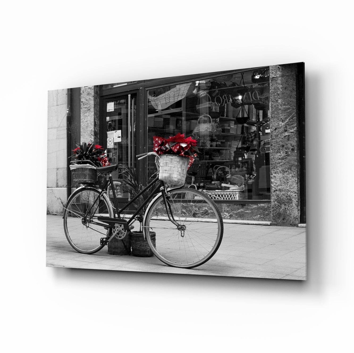 Black bicycle with red flower baskets against a monochrome storefront, glass wall art on tempered glass