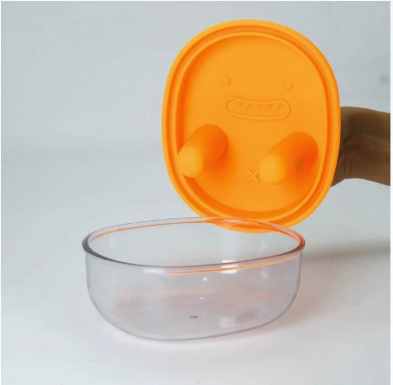 Orange hygienic snack dispenser showing button mechanism detail