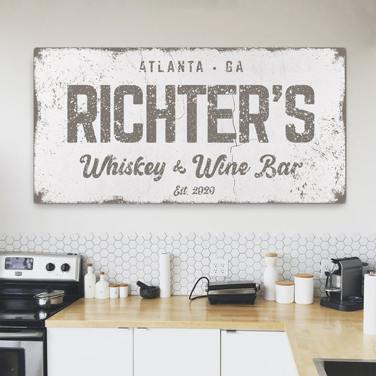 Whiskey and Wine bar canvas wall art above a home bar cart