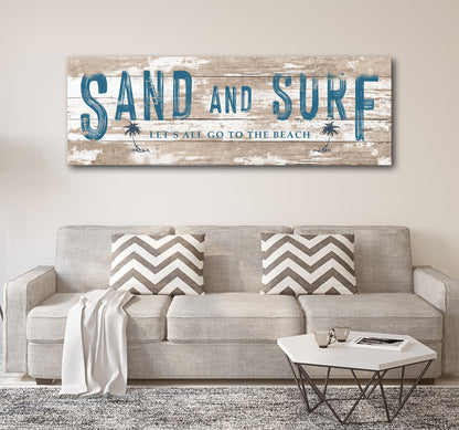 Sand and Surf sign in Style 3 with a tan plank look and palm trees, above a beige sofa