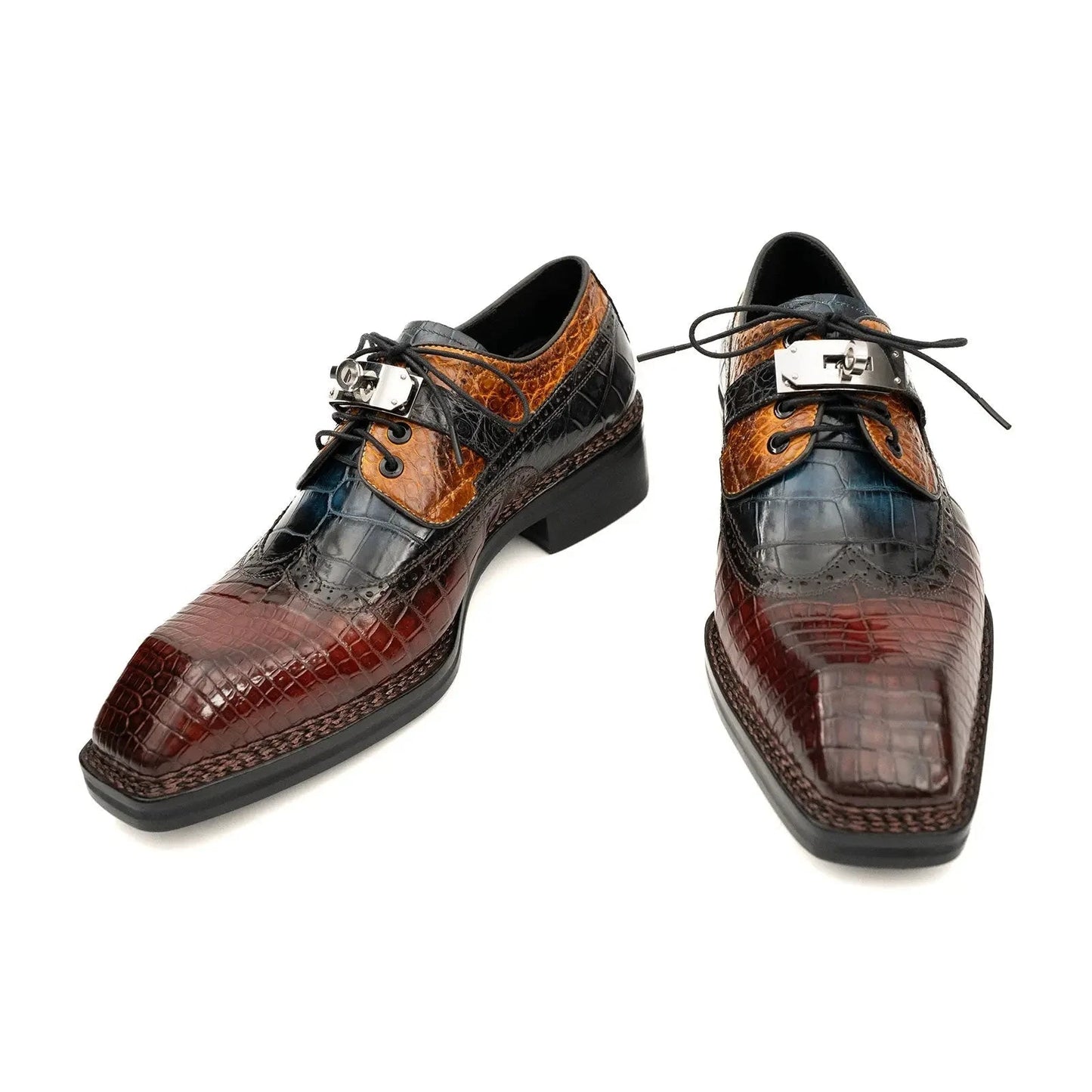 Pair of brown and black dress shoes with crocodile pattern on a white background