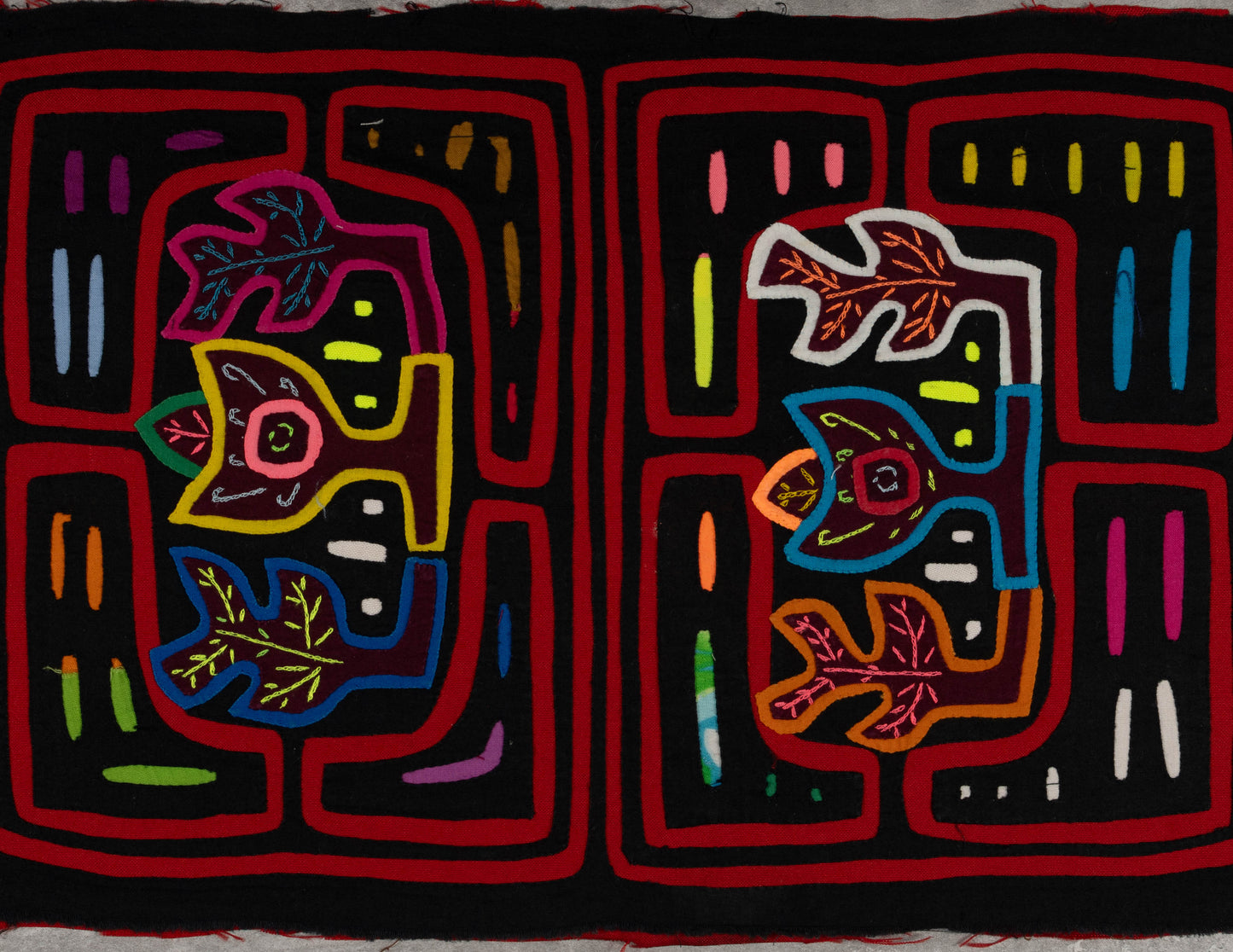 Hand-stitched Panama mola tapestry with a black and red floral motif, colorful folk-art fabric wall hanging