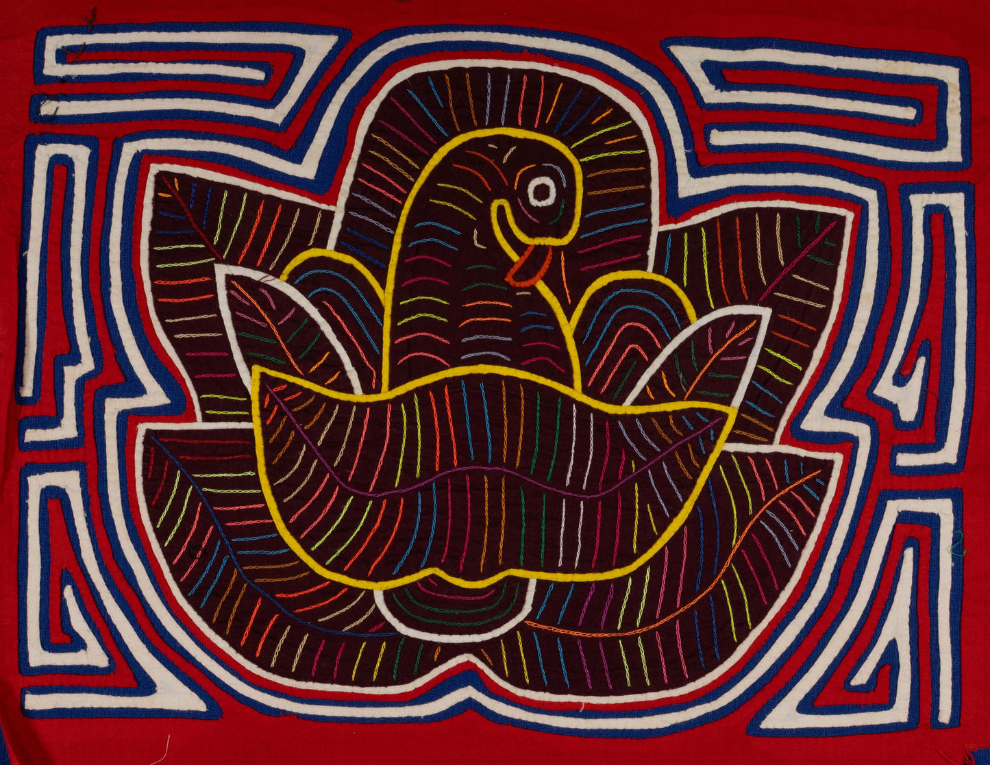 Hand-stitched Panama mola tapestry of a red, white and blue bird in a flower, colorful folk-art fabric wall hanging
